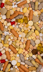 Close-up with colorful assortment of various medicine pills and capsules. Many different types of medical pills, tablets, and capsules