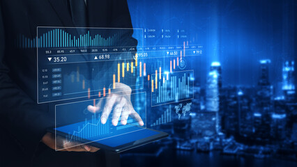 A businessman uses a tablet to analyze financial data with interactive digital graphs, set against...