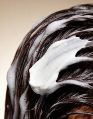 studio photography of hair textures, a lock of wet brown hair covered with white hair mask, conditioner, balm, against light beige gradient background, hair coloring, hair lightening, keratin