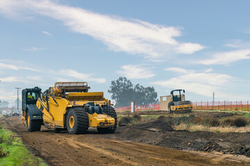 Obraz premium Powerful road machinery working in challenging conditions. Reliability, engineering precision.