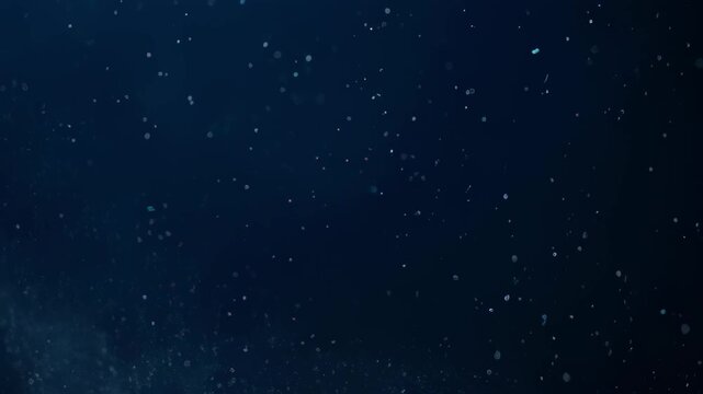 Deep, dark blue background with tiny, scattered, luminous particles