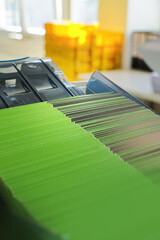 An enveloping machine at the lettershop prepares and processes letters and mailings for the post office or print shop. Print sorted with spine. Lettershop or bookbinder manufacture.