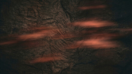 Dark textured abstract background with glowing red streaks and rough surface
