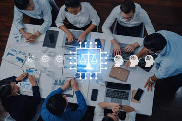 A diverse group of professionals engages in a business meeting, integrating technology with a focus...