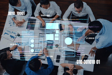 A diverse business team engages in a collaborative meeting, utilizing digital tools and data visualizations to enhance strategy and project development in an office. Trope