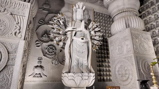 White Stone Statue of Multi-Armed Deity in Intricate Temple Interior