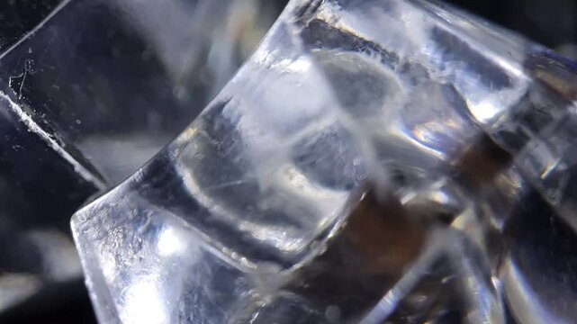 Macro shot of clear synthetic ice cubes rotating