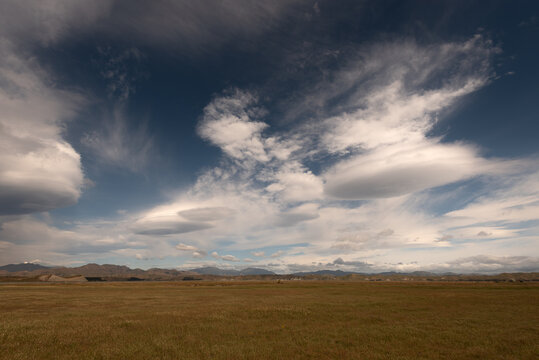 Lenticular clouds forming over the northern end of the Inland Kaikoura Range, viewed from Lake Grassmere, Marlborough, New Zealand.