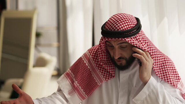 Irritated Muslim businessman arguing on phone with employee after failed deal