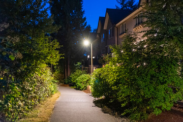 Two story stucco luxury house with big tree and nice landscape at night at Summer in Vancouver, Canada, North America. July 2025.