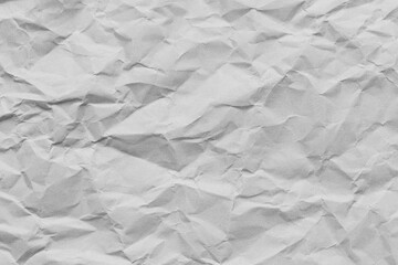 Obraz premium Crumpled white paper texture background,A high-resolution top view of a wrinkled and crumpled piece of white paper, showing detailed creases, shadows, and textures, ideal for background or overlay.