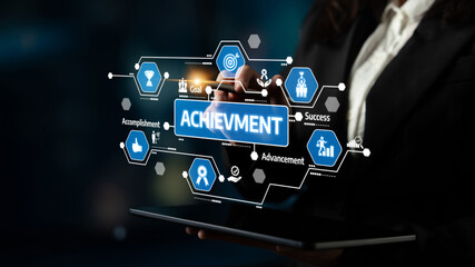 A business professional engages with digital graphics representing achievement, success, and goal-setting, showcasing modern concepts in a collaborative workspace. Tessel