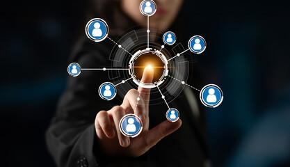 A business professional interacts with digital connections using a futuristic touchscreen...