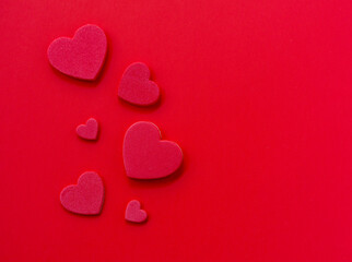 Obraz premium Red hearts on red background with copy space, Valentine’s Day minimal concept