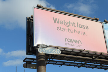 Obraz premium roadside billboard for Raven, a non‑prescription supplement brand marketed for metabolism or appetite support, Toronto