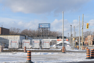 Obraz premium roadside billboard over a location of Sherwin-Williams Commercial Paint Store at 24 Carlaw Av (with Purolator courier trucks in a car park), Toronto