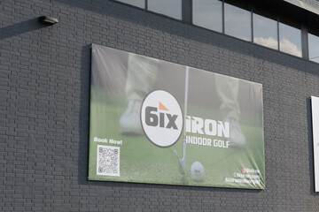 Obraz premium banner on an exterior wall for 6ix IRON, a premium indoor golf simulator facility in Toronto (either at 142 George St or 146 Dupont St)