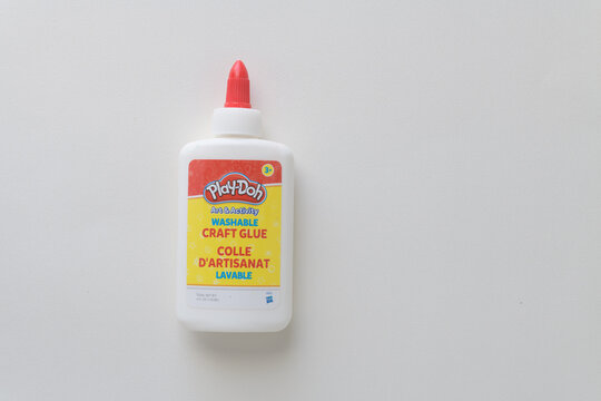 Play-Doh washable craft glue bottle isolated on blank paper