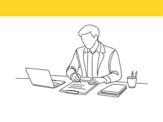 man working on laptop and writing on clipboard at desk