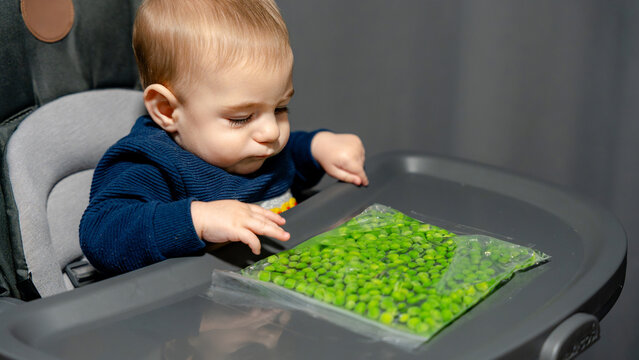 Baby exploring peas for sensory play and stimulation
