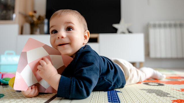 Baby enjoying playtime on colorful activity mat