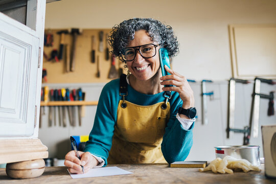 Woman in a furniture restoration workshop with tools