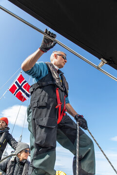 Adventurers sailing in the scenic Lofoten waters