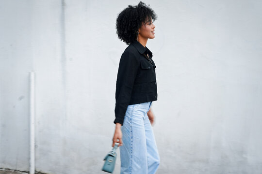 Woman walking urban street showing casual fashion style