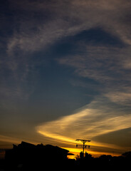 Silhouette of a building at sunset with a beautiful sky.
