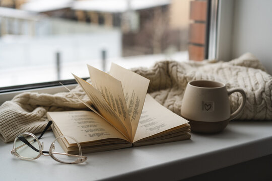 Cozy reading spot by a window with a warm atmosphere