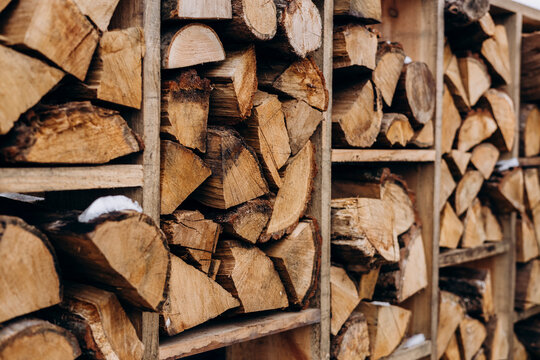 Stacked firewood logs in wooden crates