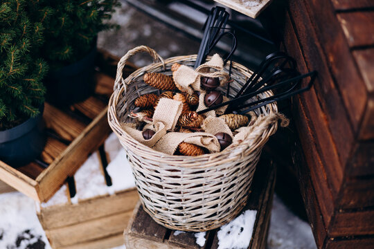 Rustic wicker basket with pine cones and burlap decor