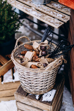Rustic winter wicker basket with pine cones and burlap accents