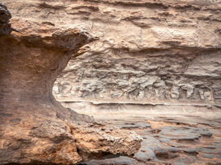 Sunlit courtyard viewed through a historic limestone archway in a Mediterranean fortress