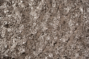 Shiny silver foil background. Top view.