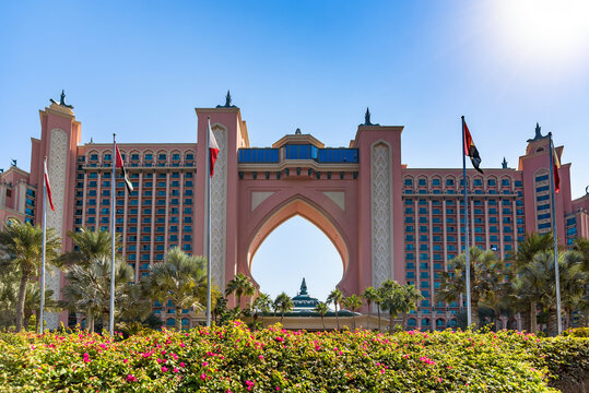 Atlantis The Palm hotel facade with UAE flags in Dubai