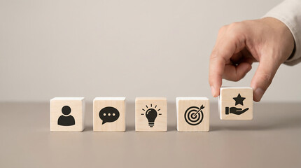 Business coaching and mentoring concept with wooden cubes person chat idea target and hand holding star on neutral background minimal studio photo with copy space