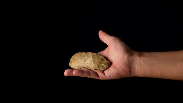 Paleolithic biface knife. Perfectly preserved. Prehistoric technology. Flakes, flint. Human manipulating the tool.
