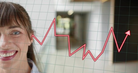 Smiling woman in collared shirt in corridor, showing red jagged chart and green grid, copy space