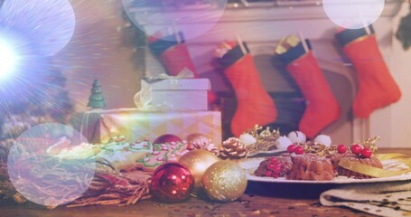 Naklejka premium Displaying festive table scene glowing on wood surface in living room with desserts and red baubles