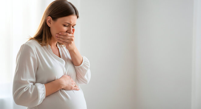 Pregnant woman experiencing nausea and morning sickness, holding her stomach and covering her mouth