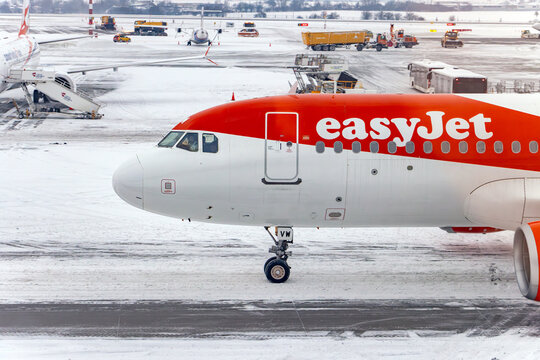 PRAGUE, CZECHIA, JAN 09 2026,Red and White Passenger Airplane of Easyjet Company Taxiing on Snowy Airport Runway in Winter