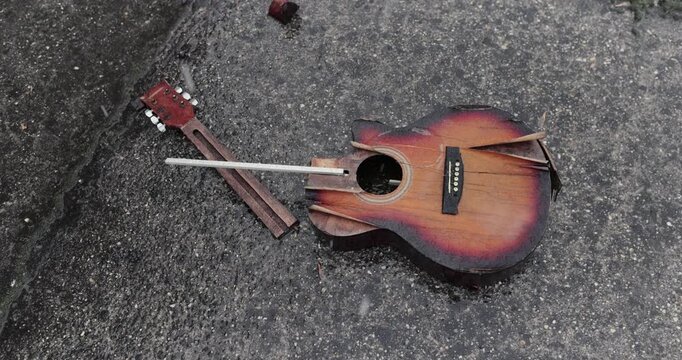 Broken guitar in snowy rain