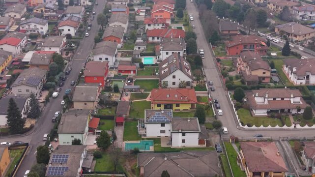 Urban Oasis: An aerial perspective unveils a harmonious neighborhood. showcasing rows of residential houses, complete with individual gardens, surrounded by a serene environment 
