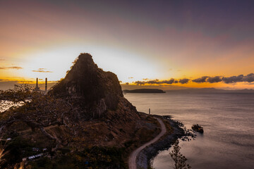 sunrise over the west philippine sea with sun hiding behind the mountain