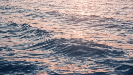 Gentle ocean waves, reflecting sunlight. Soft hues of blue and pink create a tranquil, serene seascape