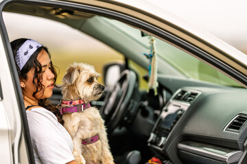 Woman and dog traveling together by car