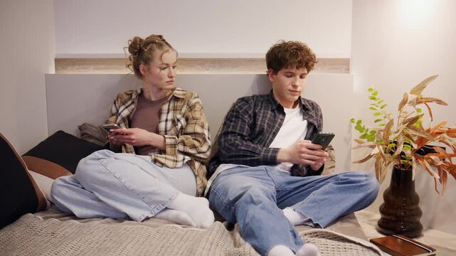 In the evening, a couple is sitting on the bed at home. The girl sees the guy texting another woman, snatches the phone and gets upset with him. There's a scandal.