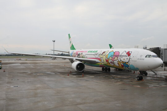 EVA Air Sanrio Characters livery aircraft parked at the airport gate.
