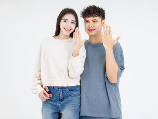 Fototapeta premium Asian young loving couple showing rings wedding love together relationship good time moment commitment sweet happy beautiful jewelry romantic marriage celebrating Valentine Day